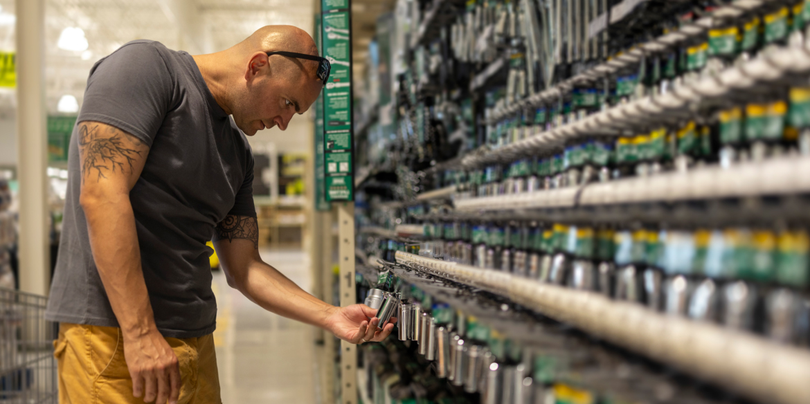 Tradesperson browsing products at shelf in a trade merchants